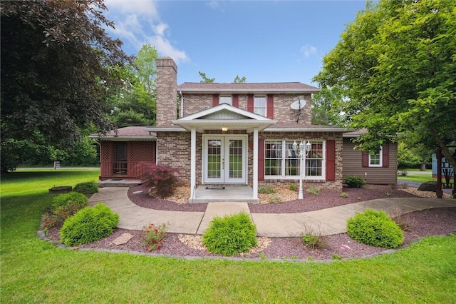 137 Painter Rd, Rayburn Twp, PA 16259 - rear view of house featuring french doors, a chimney, a lawn, and brick siding