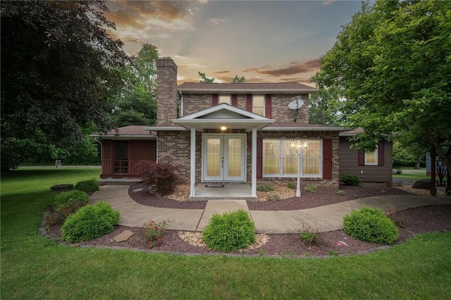 137 Painter Rd, Rayburn Twp, PA 16259 - back of property at dusk with french doors, a chimney, and a yard