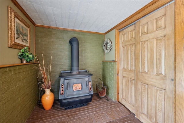 137 Painter Rd, Rayburn Twp, PA 16259 - detailed view of ornamental molding, a wood stove, brick wall, and an ornate ceiling