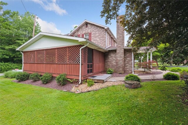 137 Painter Rd, Rayburn Twp, PA 16259 - view of side of property featuring a chimney, a yard, and brick siding