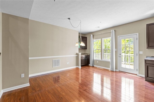 118 Maple Ridge Dr, Cecil, PA 15317 - unfurnished living room featuring wood finished floors and a chandelier