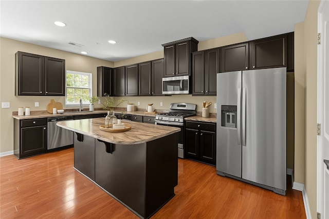 118 Maple Ridge Dr, Cecil, PA 15317 - kitchen with stainless steel appliances, light wood-style floors, a kitchen island, recessed lighting, and light stone counters