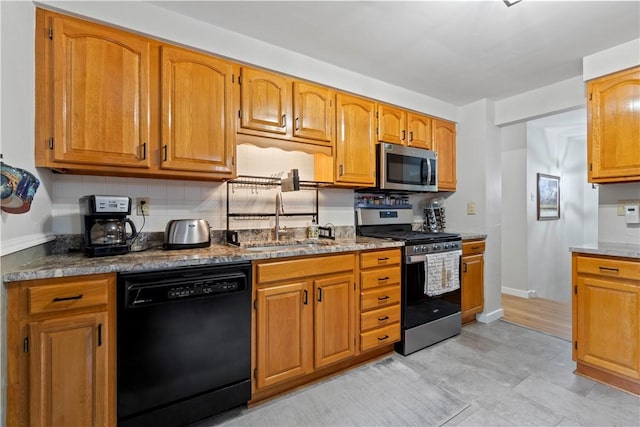 3102 Albine Dr, Shaler, PA 15116 - kitchen with stainless steel appliances, decorative backsplash, and brown cabinetry