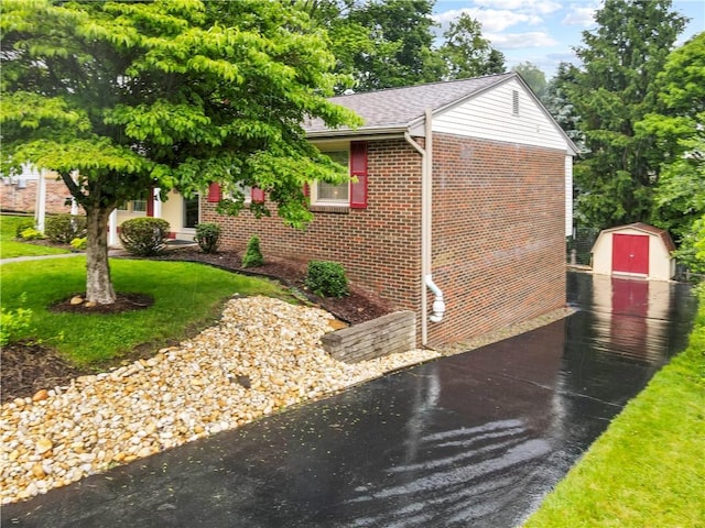 3102 Albine Dr, Shaler, PA 15116 - view of front facade with a shed, brick siding, a front yard, and a shingled roof