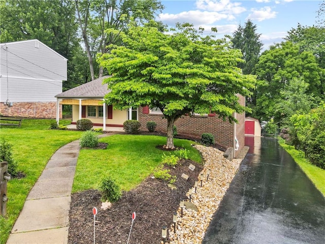 3102 Albine Dr, Shaler, PA 15116 - view of front facade with covered porch, a front yard, an outdoor structure, and brick siding