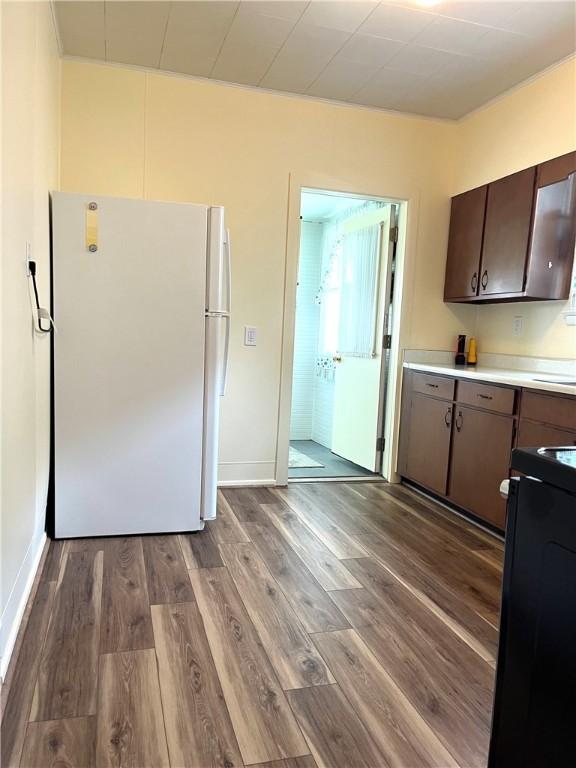 231 Center St, Slippery Rock Boro, PA 16057 - kitchen featuring freestanding refrigerator, stove, wood finished floors, light countertops, and dark brown cabinets