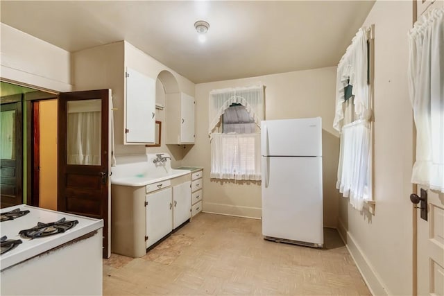 903 11th St, Ambridge, PA 15003 - kitchen with freestanding refrigerator, light countertops, white cabinetry, and light flooring