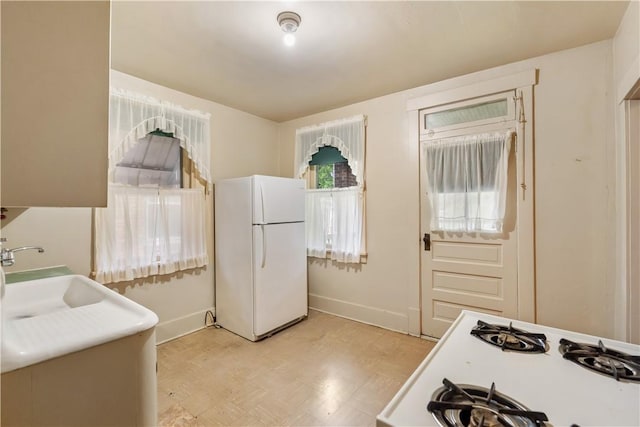 903 11th St, Ambridge, PA 15003 - kitchen with freestanding refrigerator, cooktop, and light floors