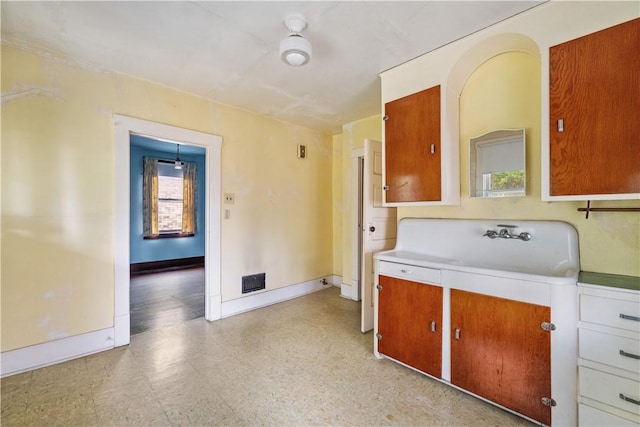 903 11th St, Ambridge, PA 15003 - kitchen with light flooring, light countertops, and brown cabinetry