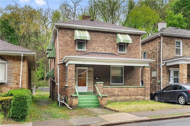 903 11th St, Ambridge, PA 15003 - american foursquare style home featuring brick siding, a chimney, a shingled roof, and covered porch