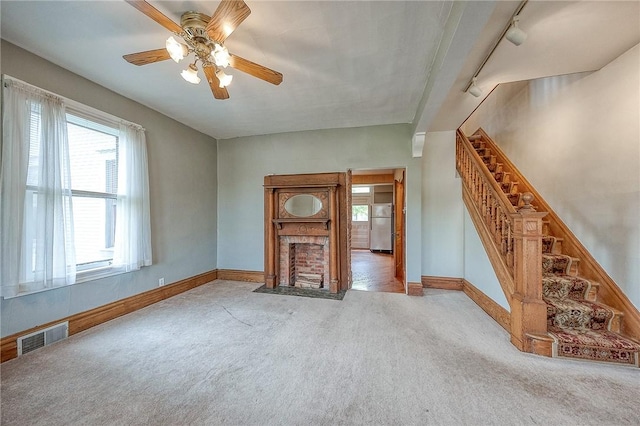1457 Orator St, Crafton Heights, PA 15204 - unfurnished living room with carpet, rail lighting, stairs, and a ceiling fan