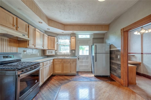 1457 Orator St, Crafton Heights, PA 15204 - kitchen with appliances with stainless steel finishes, dark wood-style floors, under cabinet range hood, light countertops, and light brown cabinets