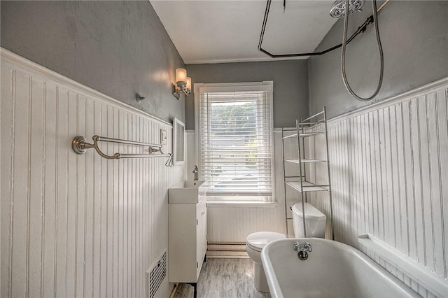 1457 Orator St, Crafton Heights, PA 15204 - bathroom featuring a freestanding tub, wood finished floors, wainscoting, and vanity