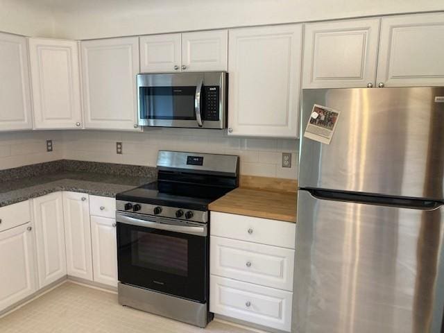 1014 State Rd, Monessen, PA 15062 - kitchen featuring appliances with stainless steel finishes, white cabinetry, and tasteful backsplash