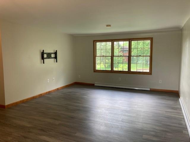 1014 State Rd, Monessen, PA 15062 - spare room with baseboard heating, dark wood-type flooring, and a baseboard radiator