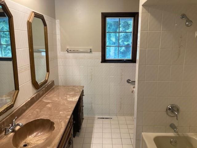1014 State Rd, Monessen, PA 15062 - full bathroom with tile patterned floors, tile walls, healthy amount of natural light, vanity, and tub / shower combination