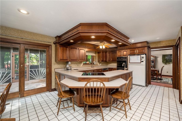 109 Old Hickory Ln, Pine Twp Mer, PA 16127 - kitchen featuring freestanding refrigerator, light countertops, black electric cooktop, a breakfast bar, and light tile patterned floors