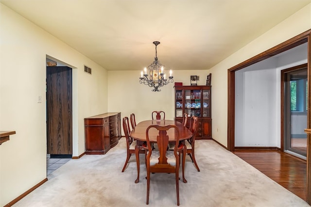 124 Oak Ln, Adams Twp, PA 16046 - dining area with a chandelier and light carpet