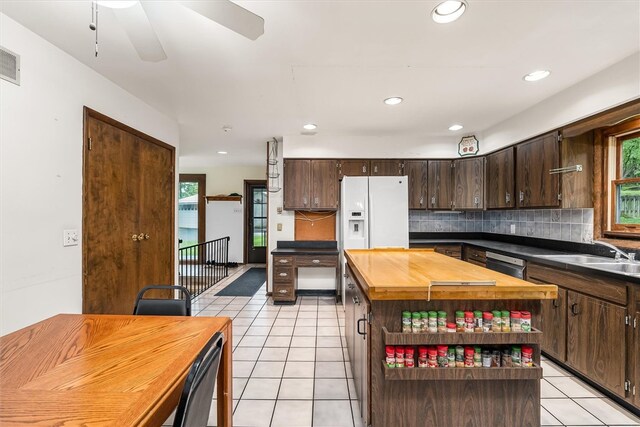 124 Oak Ln, Adams Twp, PA 16046 - kitchen featuring light tile patterned flooring, wood counters, dark brown cabinets, healthy amount of natural light, and recessed lighting