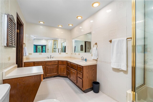 124 Oak Ln, Adams Twp, PA 16046 - bathroom with a stall shower, tile walls, double vanity, tile patterned flooring, and recessed lighting