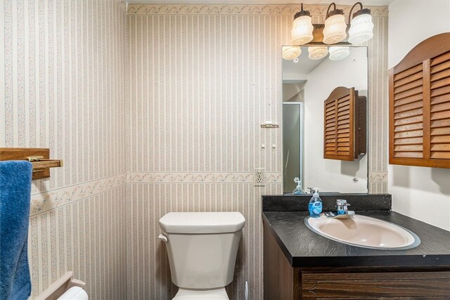 124 Oak Ln, Adams Twp, PA 16046 - bathroom with vanity, wallpapered walls, and an enclosed shower
