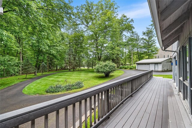 124 Oak Ln, Adams Twp, PA 16046 - deck featuring a detached garage, a yard, and view of scattered trees