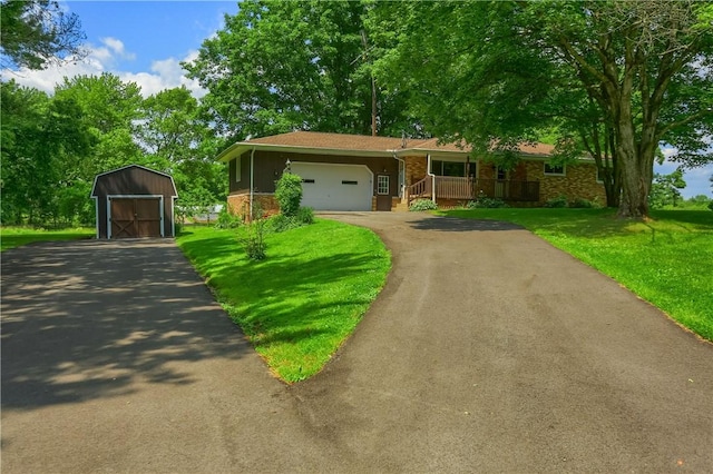 3473 Old Pulaski Rd, Wilmington Twp, PA 16105 - view of front of property with a storage unit, covered porch, a front yard, asphalt driveway, and an attached garage