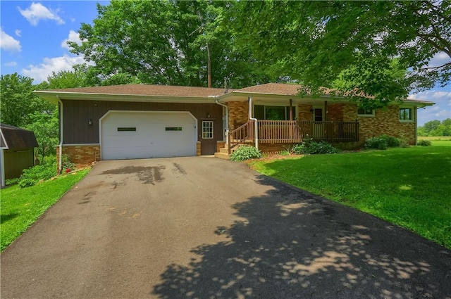 3473 Old Pulaski Rd, Wilmington Twp, PA 16105 - ranch-style home featuring asphalt driveway, brick siding, covered porch, a garage, and a front lawn