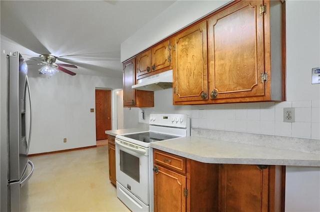 3473 Old Pulaski Rd, Wilmington Twp, PA 16105 - kitchen with white electric stove, stainless steel fridge, under cabinet range hood, decorative backsplash, and brown cabinetry
