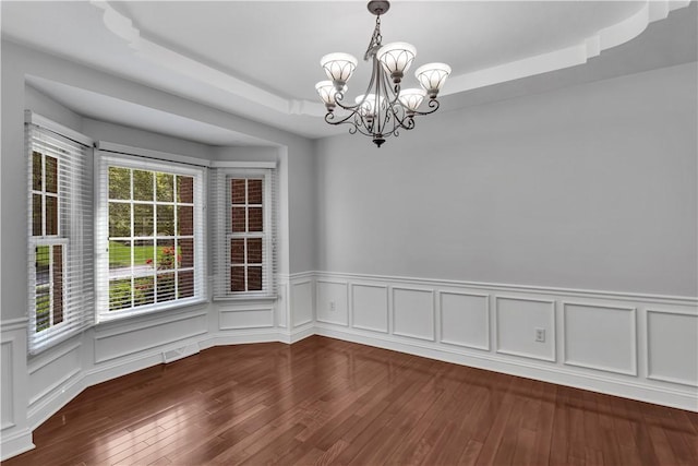 360 Steeplechase Dr, Cranberry Twp, PA 16066 - unfurnished dining area featuring a chandelier, a raised ceiling, wainscoting, and wood finished floors