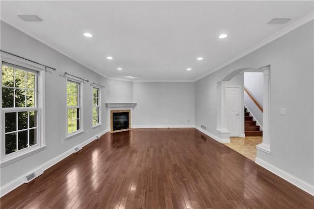 360 Steeplechase Dr, Cranberry Twp, PA 16066 - unfurnished living room featuring wood-type flooring, a glass covered fireplace, recessed lighting, arched walkways, and crown molding