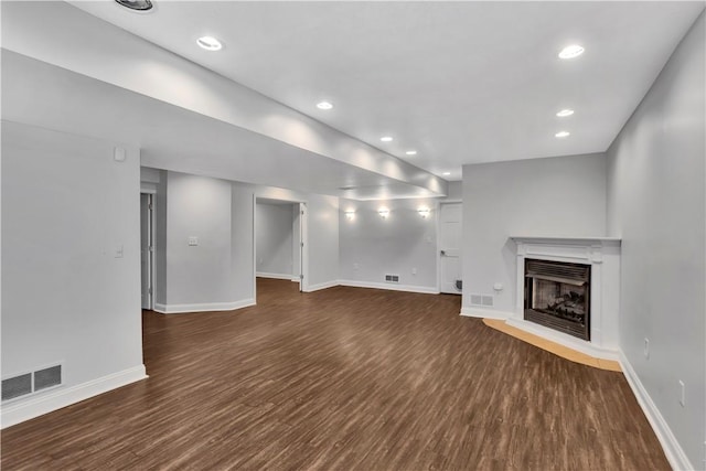 360 Steeplechase Dr, Cranberry Twp, PA 16066 - unfurnished living room with dark wood finished floors, a fireplace with raised hearth, and recessed lighting