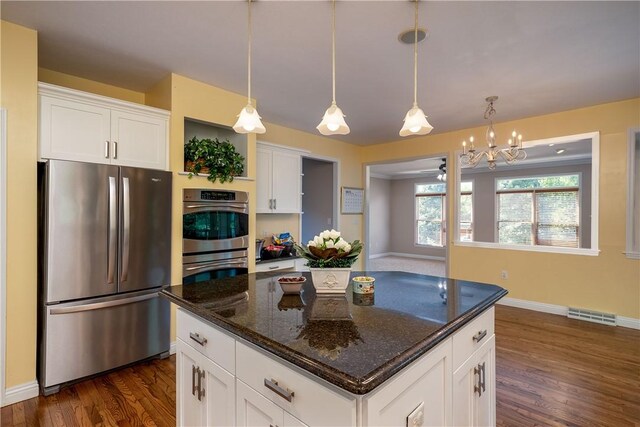 130 Sewickley Farm Cir, Marshall, PA 16046 - kitchen with stainless steel appliances, dark wood-style floors, white cabinetry, and dark stone counters