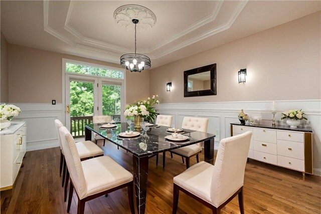130 Sewickley Farm Cir, Marshall, PA 16046 - dining area featuring a raised ceiling, a wainscoted wall, wood finished floors, ornamental molding, and a chandelier