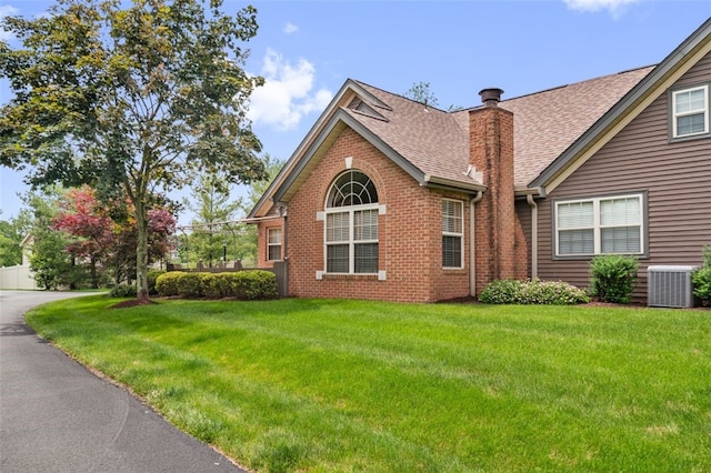 6422 Jefferson Pointe Cir, Jefferson Hills, PA 15025 - view of side of home featuring roof with shingles, a chimney, a lawn, and brick siding