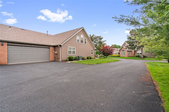 6422 Jefferson Pointe Cir, Jefferson Hills, PA 15025 - view of front of home featuring asphalt driveway, an attached garage, brick siding, and a front lawn