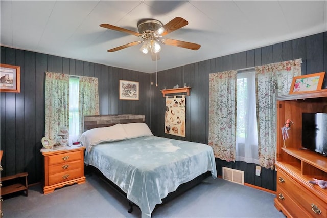 1059 Old Princeton Rd, Shenango Twp Law, PA 16101 - bedroom featuring multiple windows, carpet floors, wooden walls, and a ceiling fan