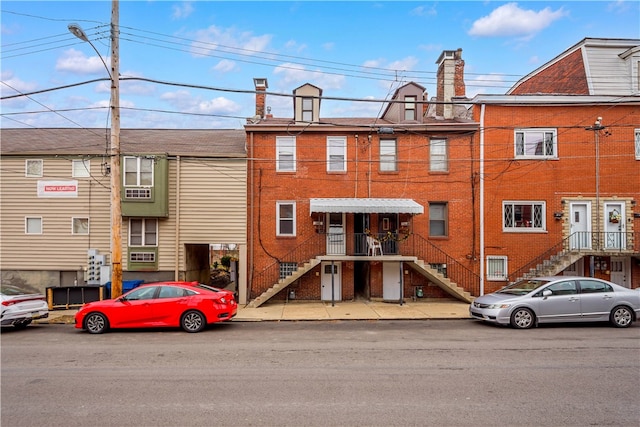 41 S 13th St, South Side, PA 15203 - view of front of property featuring stairs, a chimney, and brick siding