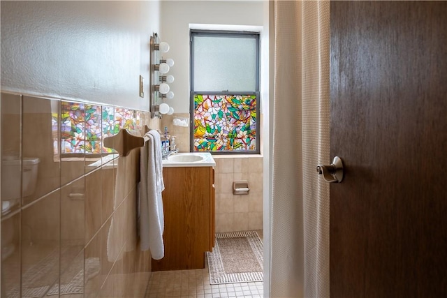 41 S 13th St, South Side, PA 15203 - bathroom with tile walls, vanity, a stall shower, and tile patterned floors