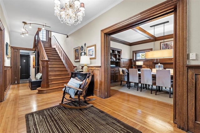 6909 Meade St, Point Breeze, PA 15208 - foyer with hardwood / wood-style flooring, healthy amount of natural light, stairs, a wainscoted wall, and a chandelier