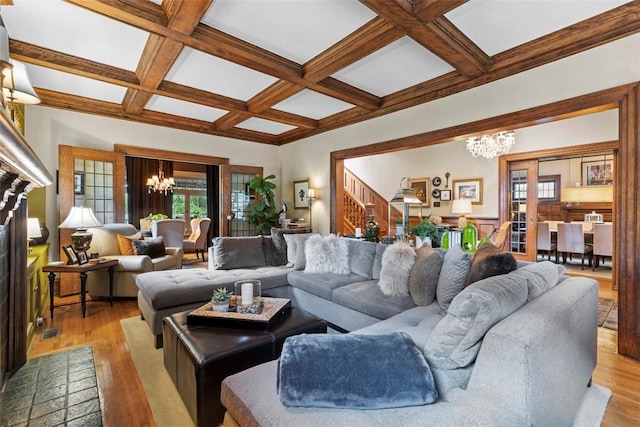 6909 Meade St, Point Breeze, PA 15208 - living area with a chandelier, coffered ceiling, beamed ceiling, light wood finished floors, and stairs
