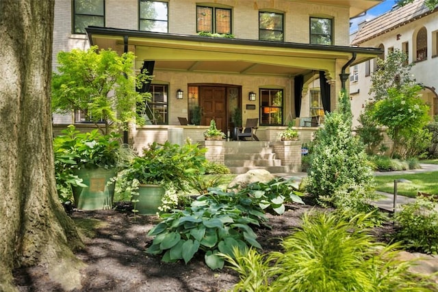 6909 Meade St, Point Breeze, PA 15208 - view of exterior entry featuring covered porch and brick siding