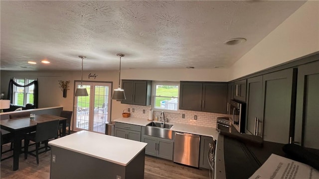 110 Mohawk Dr, Buffalo Twp But, PA 16055 - kitchen featuring appliances with stainless steel finishes, healthy amount of natural light, light countertops, tasteful backsplash, and a textured ceiling