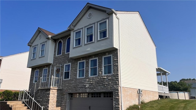110 Mohawk Dr, Buffalo Twp But, PA 16055 - view of property featuring an attached garage, stone siding, and stairway