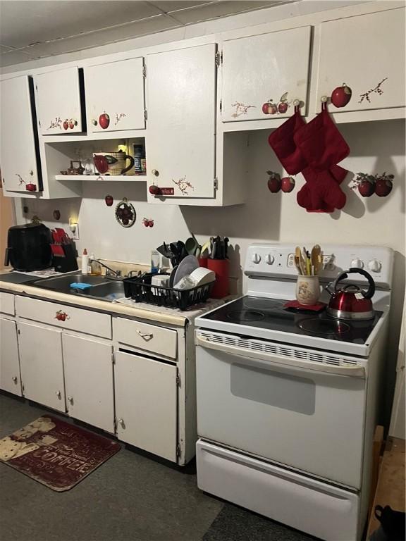 907 E Washington St, New Castle/4Th, PA 16101 - kitchen with white range with electric stovetop, light countertops, white cabinetry, and open shelves
