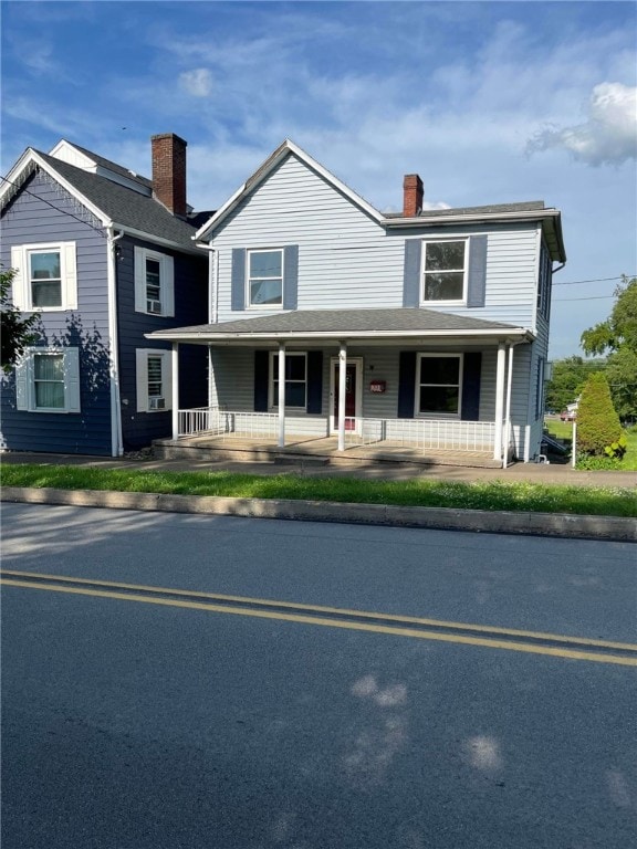 114 N Main St, Masontown, PA 15461 - view of front facade featuring a porch and a chimney
