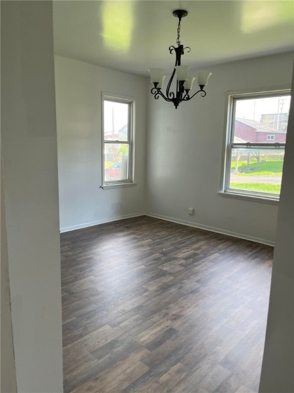114 N Main St, Masontown, PA 15461 - spare room with healthy amount of natural light, a chandelier, and dark wood-type flooring