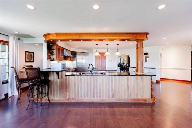 7 Shepherds Ln, North Strabane, PA 15330 - kitchen featuring wall chimney exhaust hood, stainless steel built in refrigerator, a peninsula, dark countertops, and arched walkways