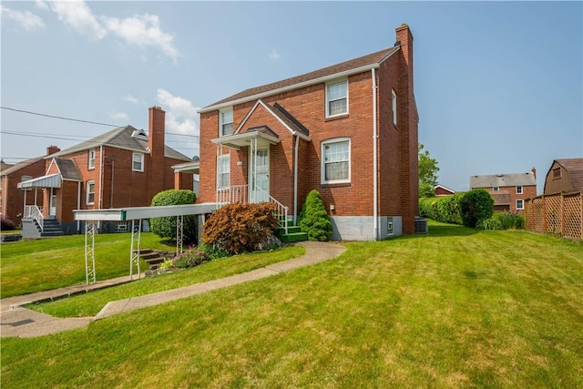 33 S Vireo Dr, Kennedy Twp, PA 15136 - view of front of property featuring brick siding, a chimney, and a front yard