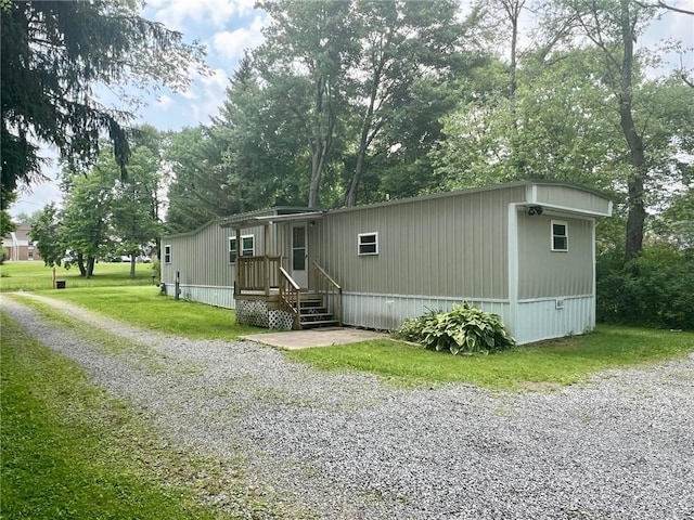 25 Coolspring St, Coolspring Twp, PA 16137 - manufactured / mobile home featuring a front lawn and view of scattered trees